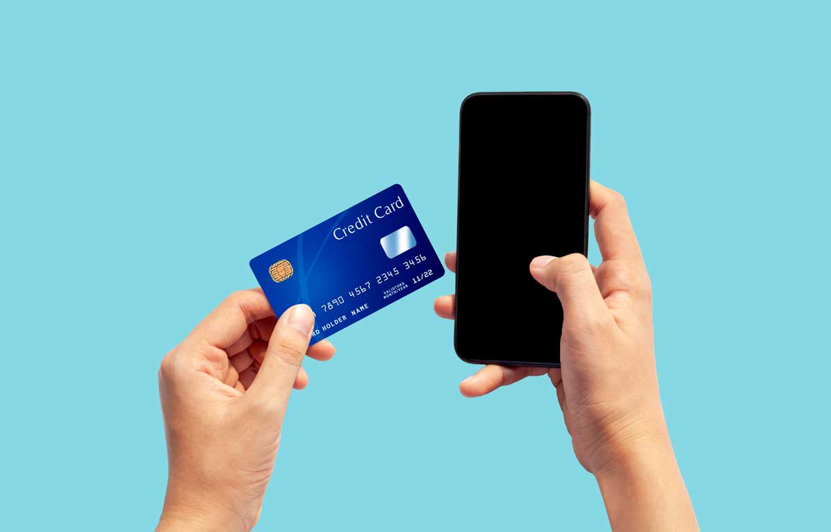 Woman Hand Holding Blue Credit Card And Using Smart Phone Isolated On Blue Background, Front Side View